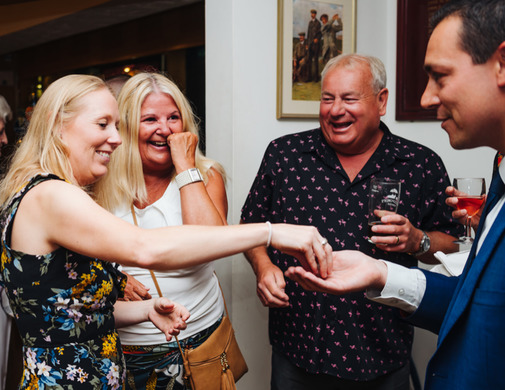 Group laughing with Nick- wedding magician at Wensum valley Hotel Norwich