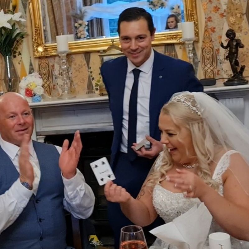 Card trick with wedding couple